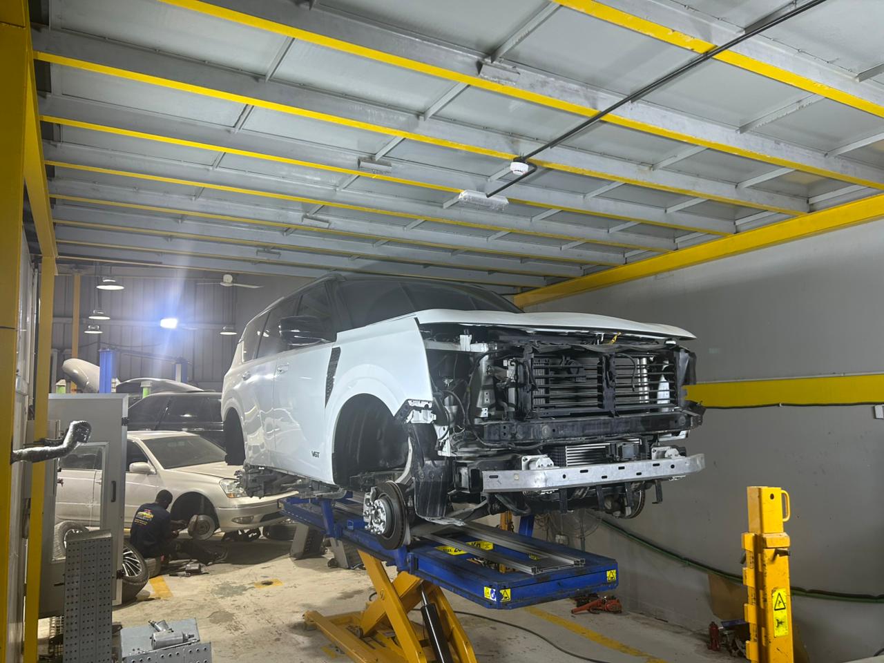 Drive Zone Auto Repair technicians using Car-O-Liner computerized chassis measurement for frame repair in Sharjah