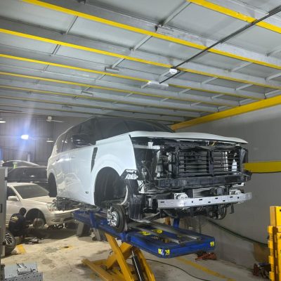 Drive Zone Auto Repair technicians using Car-O-Liner computerized chassis measurement for frame repair in Sharjah